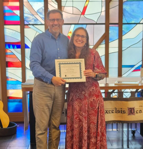 Naoma Riordan receiving her spiritual direction formation certificate at her May 2026 completion ceremony.